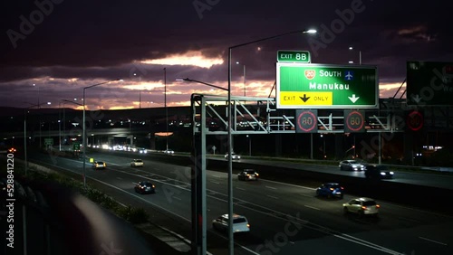 Orange, cloudy sunset over highway 20 leading south in Aucklands western suburbs photo