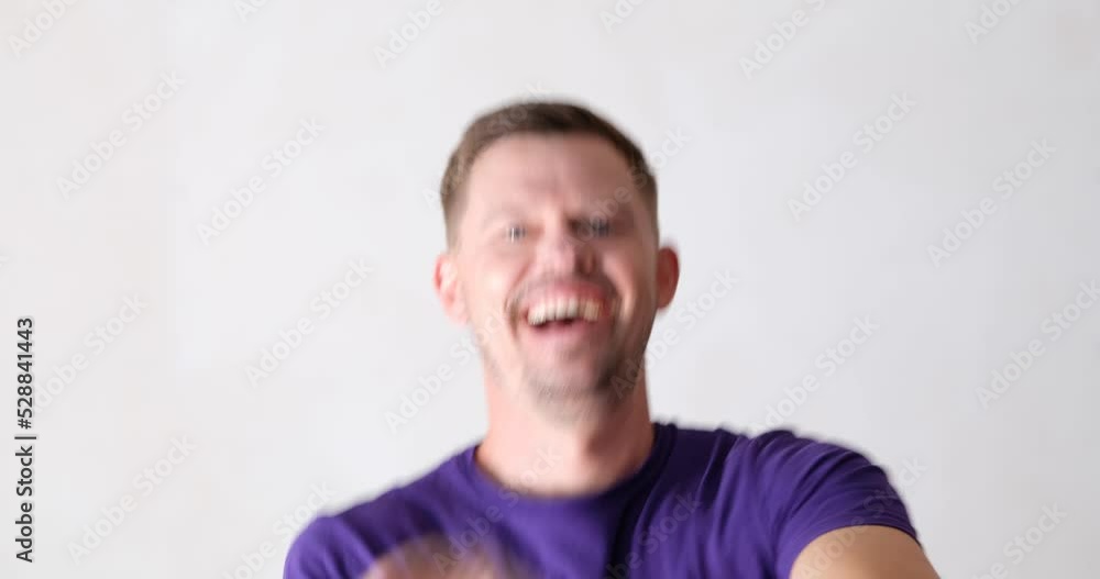 Portrait of cheerful happy man dancing towards camera Portrait of cheerful happy man dancing towards camera