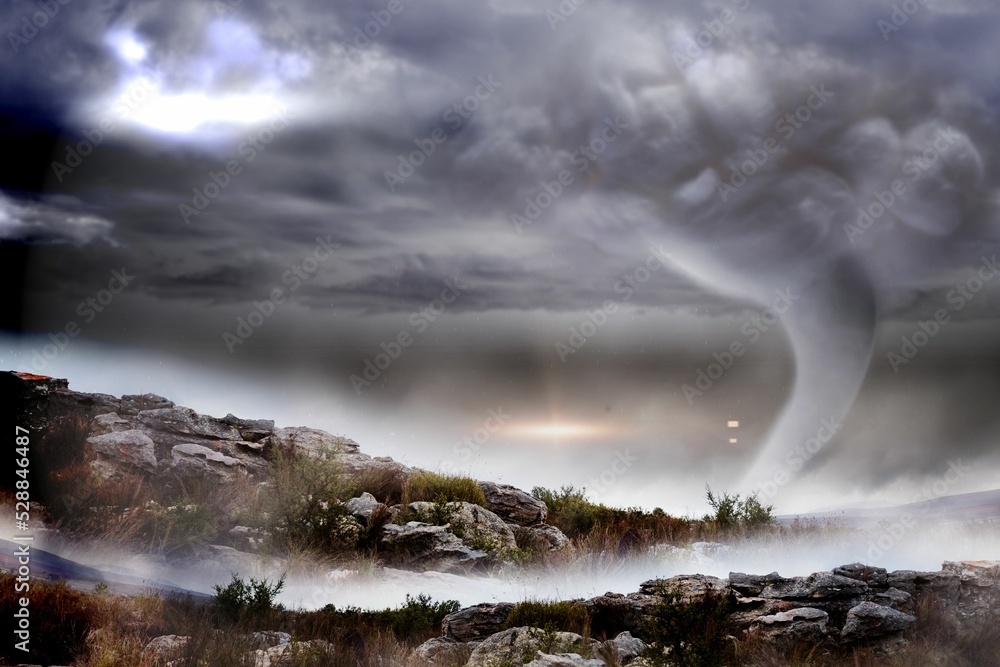 Stormy sky with tornado over landscape