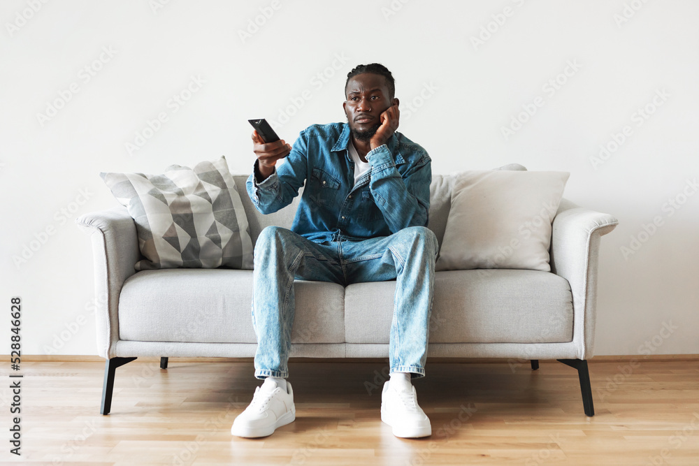 Bored Black Guy Watching Movie On TV Sitting At Home