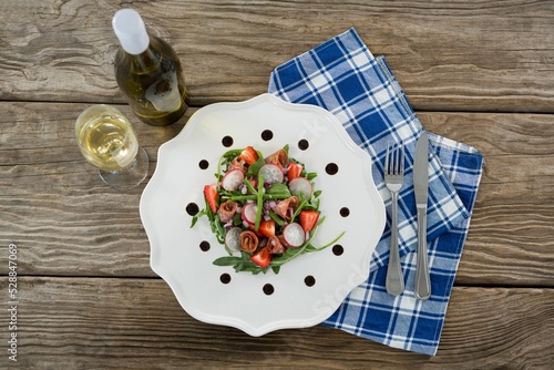 Fresh food with white wine served in wooden table