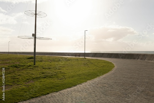 Front view of lampposts on the coast line against blue sky