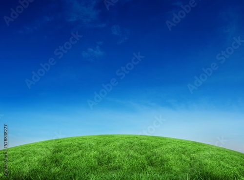Green hill under blue sky