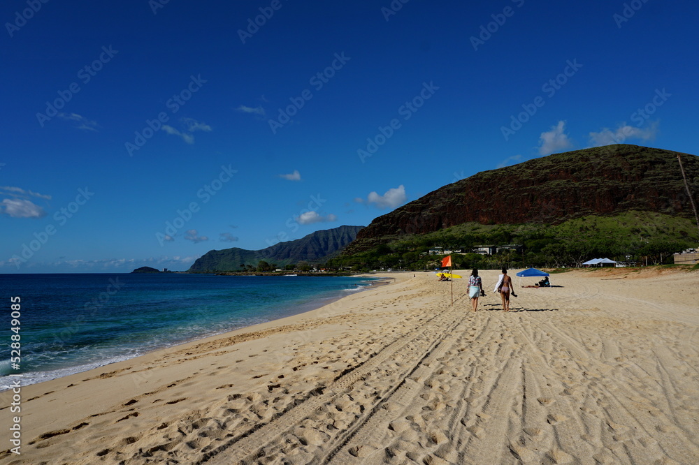 Fototapeta premium Women walking on the beach in Oahu Hawaii