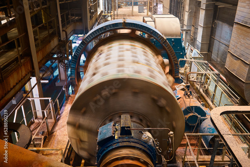 Huge grinding ball mill operates with mineral ore at plant