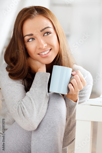 Relax, home and woman thinking with coffee, tea or hot chocolate happy with a smile while relaxing in her house. Beauty, peace and girl with calm energy and morning cup of espresso enjoy alone time