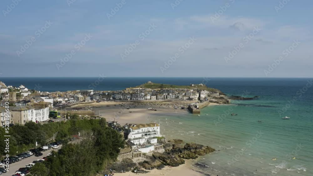 People At Porthminster Beach Overlooking Harbour In St Ives Bay, Cornwall, England. Aerial Drone Shot People At Porthminster Beach Overlooking Harbour In St Ives Bay, Cornwall, England. Aerial Drone Shot