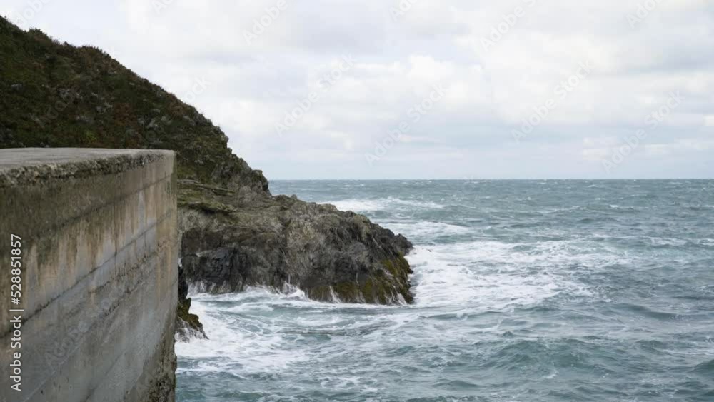 Huge Waves Hit On The Rocky Shore Of Newquay Harbour In Cornwall, England. Static Shot Huge Waves Hit On The Rocky Shore Of Newquay Harbour In Cornwall, England. Static Shot