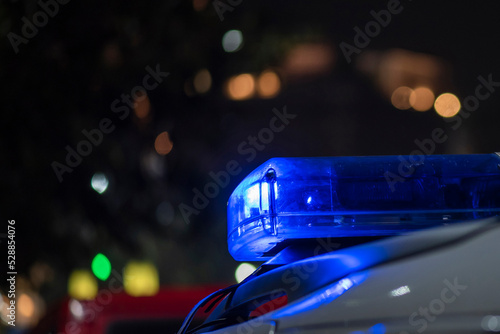 Emergency light of police patrolling car on street in night © suman
