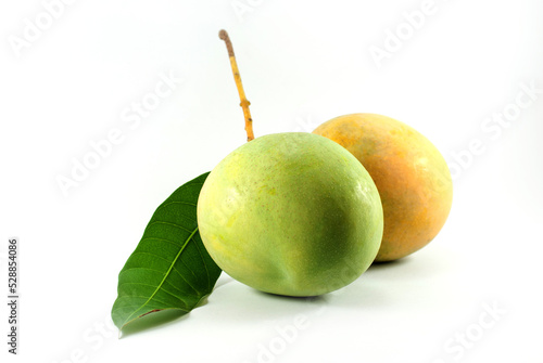 Raw and ripe mangoes on white background. photo