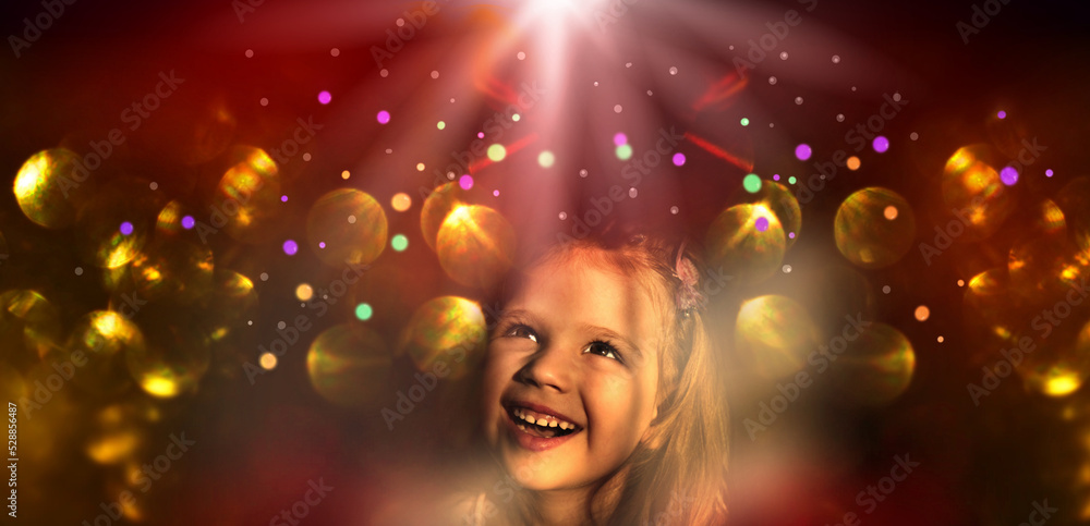 Pretty little child girl with xmas lights bokeh. Kid enjoy the holiday. Christmas and New Year concept. Happy, wishing, waiting. Merry Christmas and happy holidays!