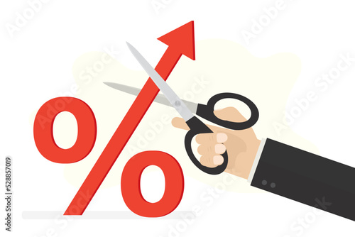 Stop Inflation, concept. High interest rates on loans. Economic crisis, Fed raised central bank interest rate to curb soaring inflation. Hand cuts percentage mark with scissors.
