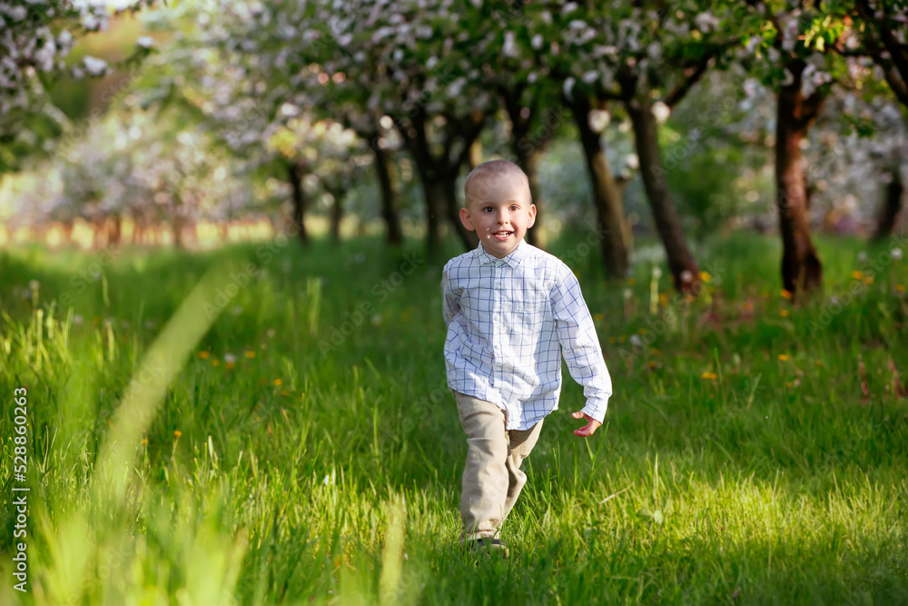 A happy child runs through the spring garden.