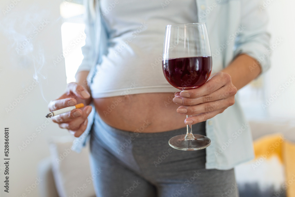 Smoking and alcohol pregnancy.woman on a long pregnancy drinking