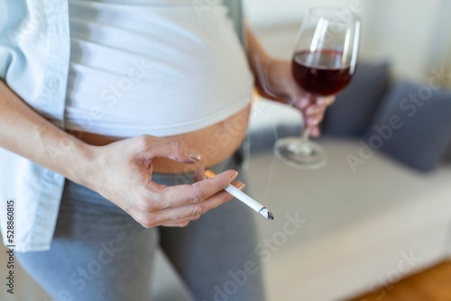 Smoking and alcohol pregnancy.woman on a long pregnancy drinking alcohol and Smoking cigarettes.problems of alcoholism and the period of bearing a child.danger of losing a baby, miscarriage. alcoholic