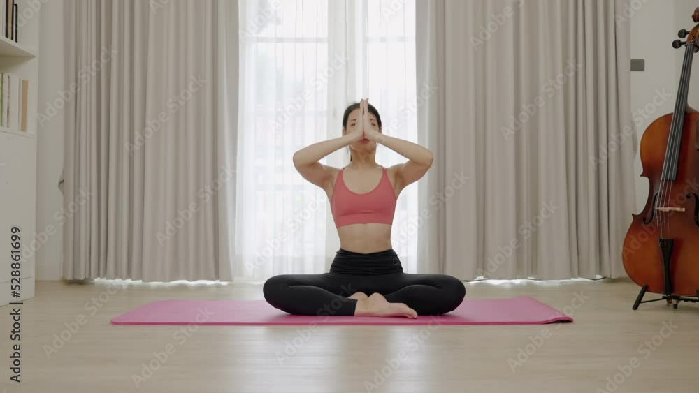 Asian woman's flexibility training while doing yoga exercises in her home.
Asian woman's flexibility training while doing yoga exercises in her home.