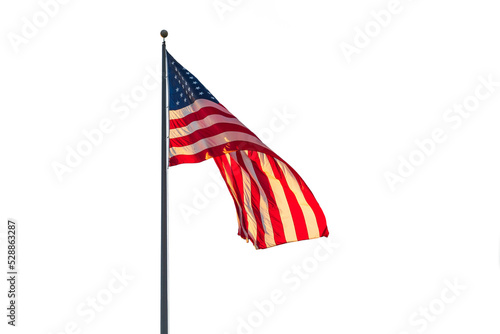 Photo of an American flag on a flying on a flagpole. photo