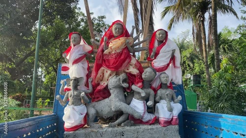 Goddess Durga Maa, Lakshmi Maa, Saraswati Maa, Lord Ganesha, and Lord Kartik's clay idols being transported into a blue-colored truck for Durga Puja photo