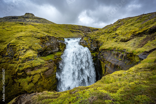 waterfall, river and country volcanic landscape with rocks, Iceland