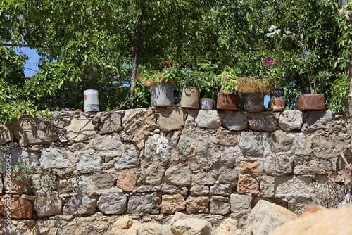 stone wall with flowers in garden