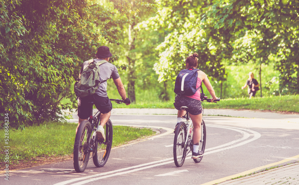 Cyclists ride on the bike path in the city Park
