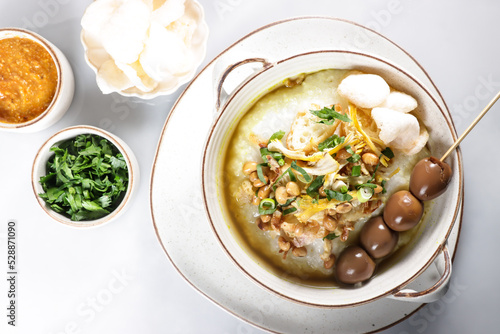 Bubur Ayam or Indonesian Rice Porridge with Shredded Chicken, cheese stick and cakwe.