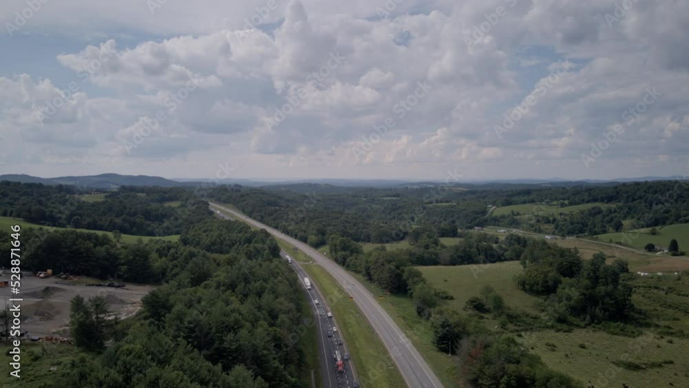 Aerial crane hyperlapse shot revealing fast traffic on Interstate 40 in North Carolina with afternoon clouds. Aerial crane hyperlapse shot revealing fast traffic on Interstate 40 in North Carolina with afternoon clouds.