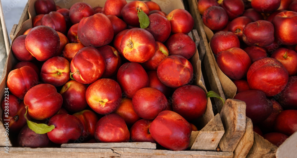 ripe fresh red nectarines in boxes on the market ripe fresh red nectarines in boxes on the market