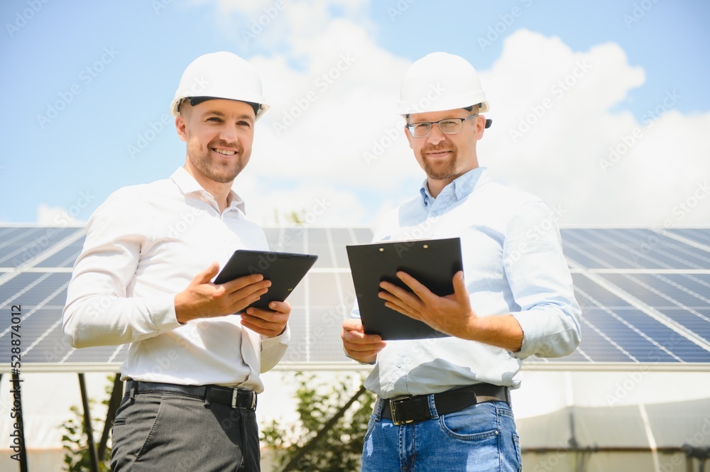 The solar farm(solar panel) with two engineers walk to check the operation of the system, Alternative energy to conserve the world's energy, Photovoltaic module idea for clean energy production