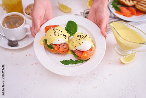 Eggs Benedict with Cream cheese and Smoked salmon on a plate photo