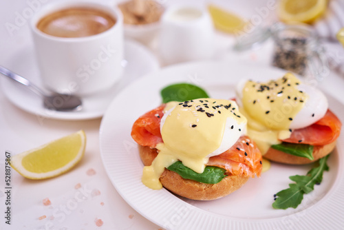 Eggs Benedict with Cream cheese and Smoked salmon on a plate photo