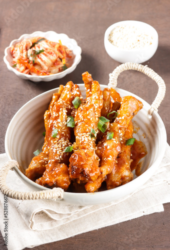 Dakbal or Maeun Dakbal is Spicy Chicken Feet Stew, Korean Food Style served with sesame seeds and Kimchi. Cakar Ayam Pedas. photo