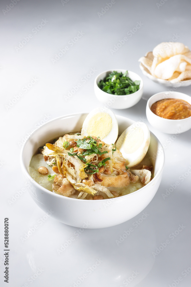 Bubur Ayam or Indonesian Rice Porridge with Shredded Chicken, cheese stick and cakwe. Bubur Ayam or Indonesian Rice Porridge with Shredded Chicken, cheese stick and cakwe.