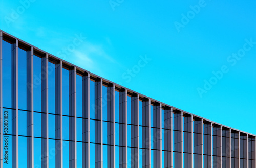 Wallpaper Mural Fragment of the mirror wall of the building against the blue sky..office building covered with glass. Place for an inscription, advertising. Torontodigital.ca