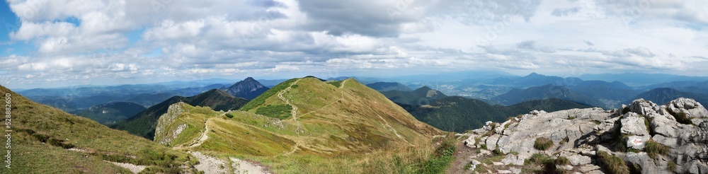 Beautiful panorama photography from a Slovakia mountains, nice weather, white clouds in a blue sky and stones and walley trough the mountains