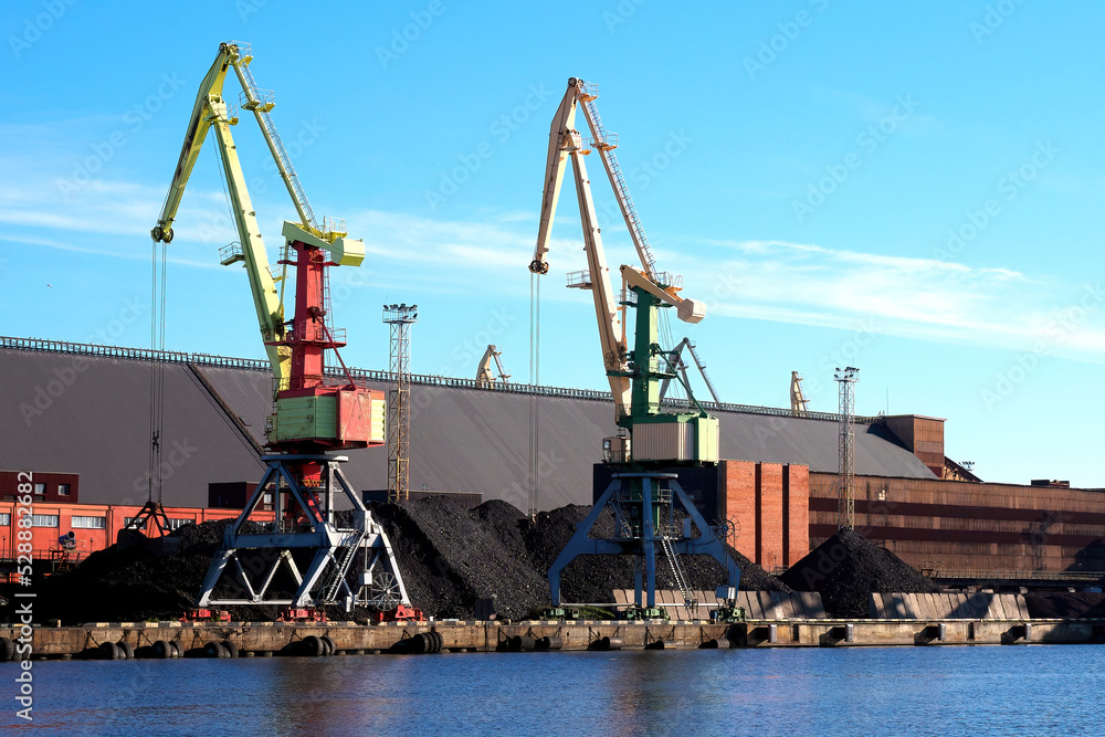 Coal terminal. Two port cranes are ready to load coal. Ventspils, Latvia.