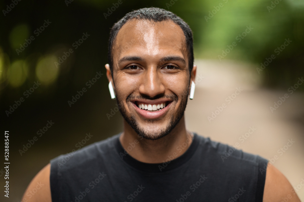 Handsome african american guy exercising at public park