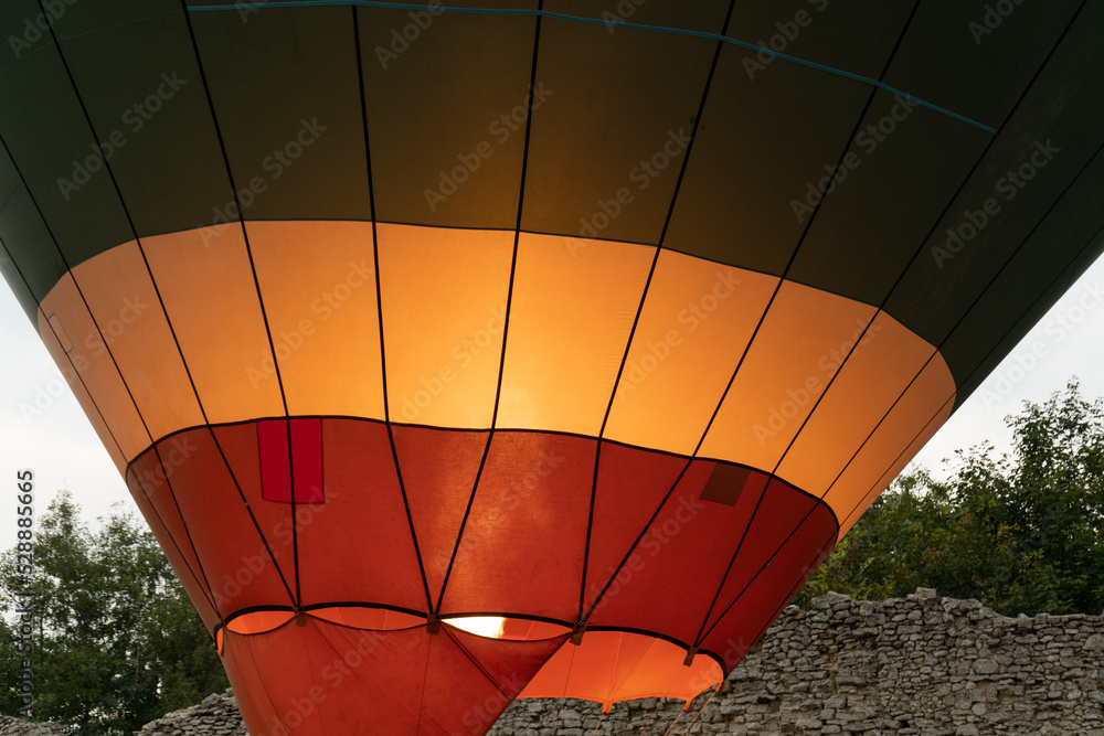 Obraz premium Hot air balloon gas burner directing fire flames into envelope. Ballooning equipment to move the balloon off the ground and into the air.