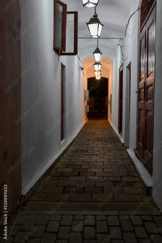 narrow passageway in the city at night