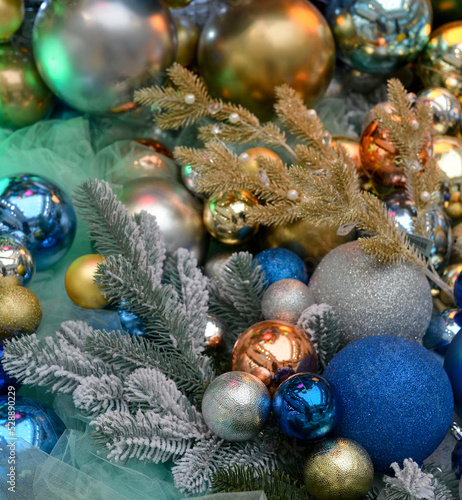 Christmas decoration: lots of blue, gold and silver balls lie next to the spruce branches. Traditional New Year's decor,winter holiday at home.