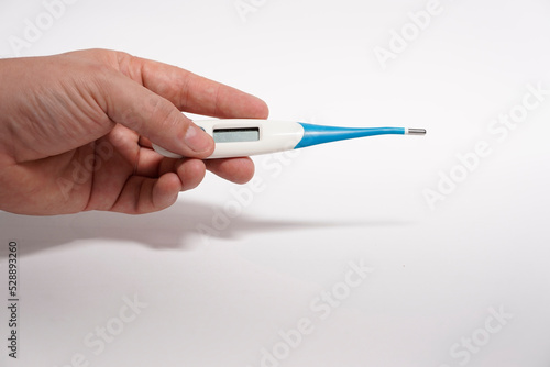 man's hand holding a baby thermometer with flexible tip