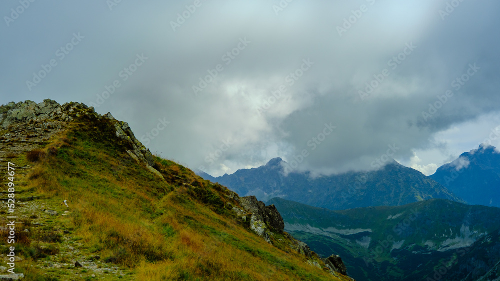 low hanging clouds and fog in the mountains at a summer day low hanging clouds and fog in the mountains at a summer day