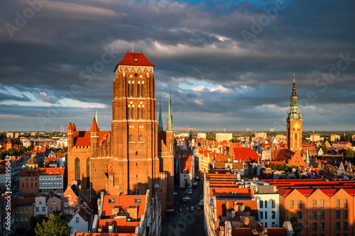 Beautiful architecture of the St. Marys Basilica of Gdansk in the rays of the setting sun. Poland