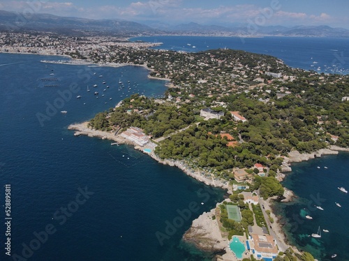 Aerial view of Cap d'Antibes and  Billionaire's Bay. Beautiful rocky beach near coastal path on the Cap d'Antibes, Antibes, France. Drone view from above of Côte d’Azur near Juan-les-Pins and Cannes. © AerialDronePics
