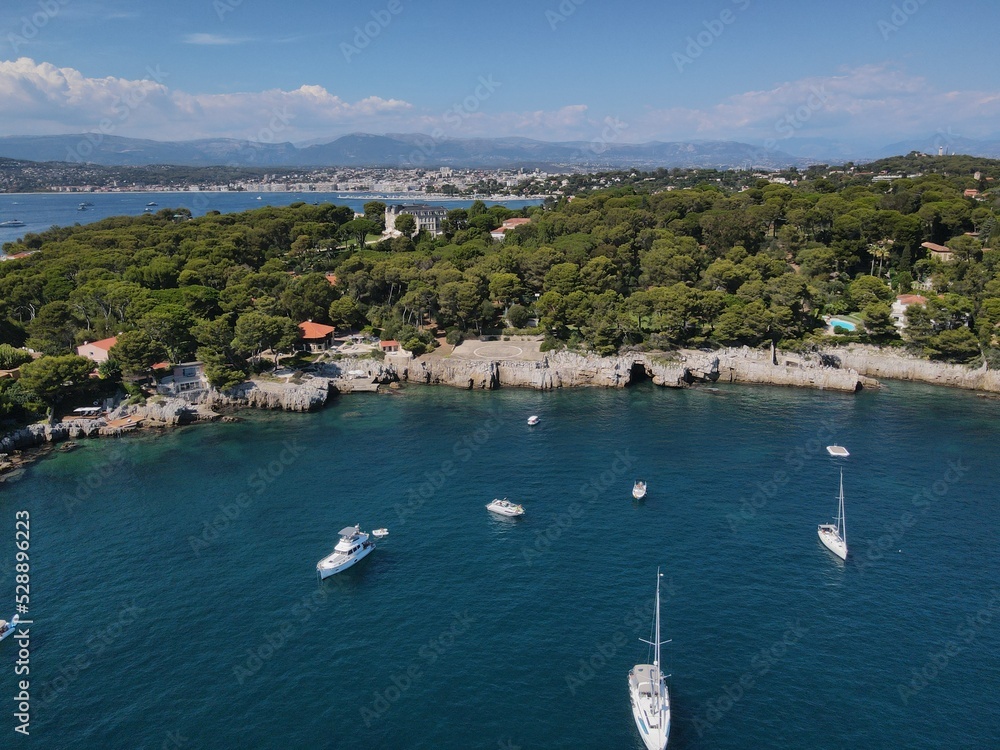 Aerial view of Cap d'Antibes and Billionaire's Bay. Beautiful rocky beach near coastal path on the Cap d'Antibes, Antibes, France. Drone view from above of Côte d’Azur near Juan-les-Pins and Cannes. Aerial view of Cap d'Antibes and Billionaire's Bay. Beautiful rocky beach near coastal path on the Cap d'Antibes, Antibes, France. Drone view from above of Côte d’Azur near Juan-les-Pins and Cannes.