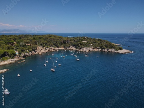 Aerial view of Cap d'Antibes and Billionaire's Bay. Beautiful rocky beach near coastal path on the Cap d'Antibes, Antibes, France. Drone view from above of Côte d’Azur near Juan-les-Pins and Cannes.