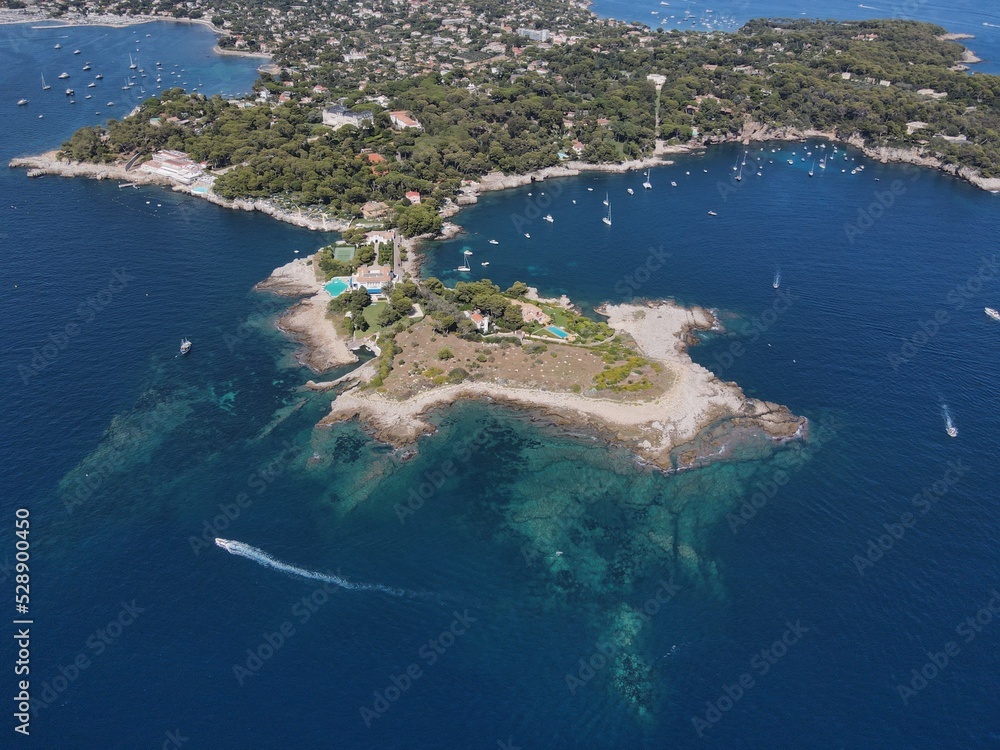 Aerial view of Cap d'Antibes and  Billionaire's Bay. Beautiful rocky beach near coastal path on the Cap d'Antibes, Antibes, France. Drone view from above of Côte d’Azur near Juan-les-Pins and Cannes.