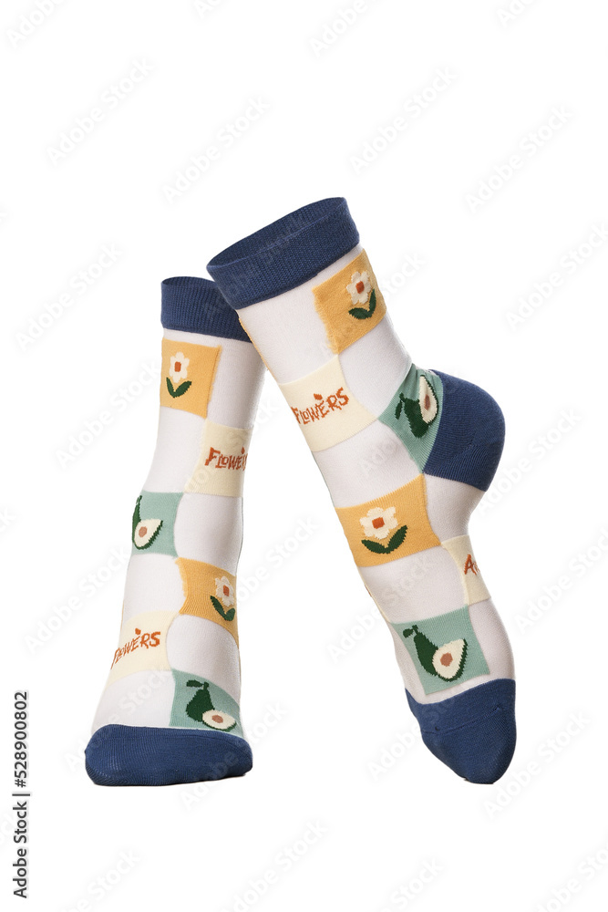 Detailed shot of colored translucent socks with a rubber band and a floral print. The socks are shaped as human legs. The textured vegetable print socks are isolated on a white background. Detailed shot of colored translucent socks with a rubber band and a floral print. The socks are shaped as human legs. The textured vegetable print socks are isolated on a white background.