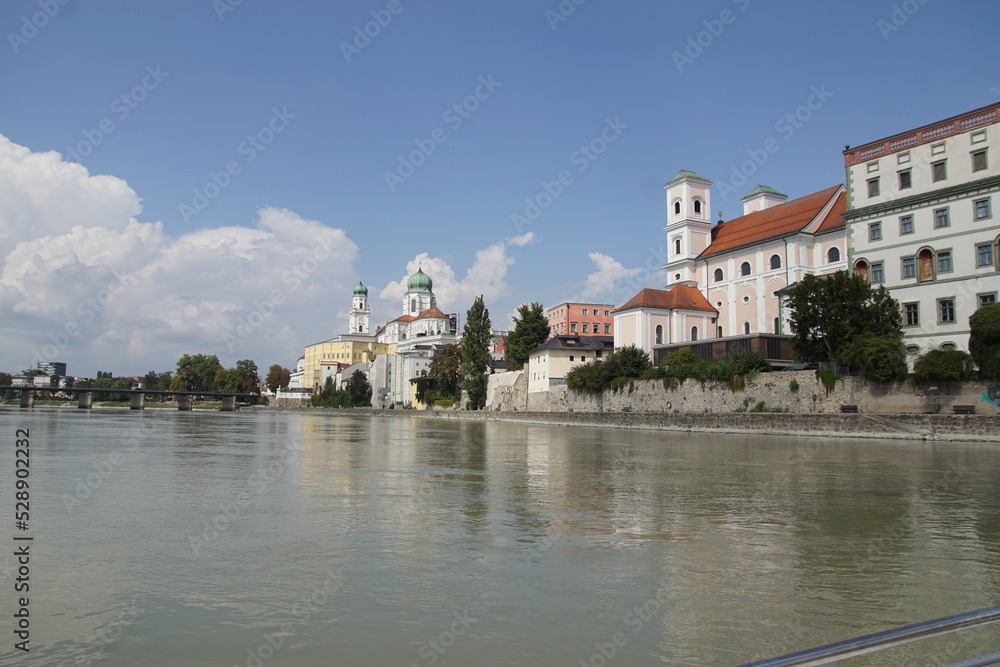 View from a sightseeing boat at the German city of Passau with the St. Stephen's Cathedral. Sailing on the Inn River. Summer, August, Germany.