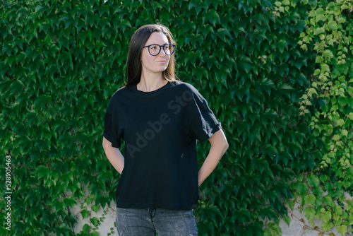 Woman wearing black blanck t-shirt with empty space for your logo photo